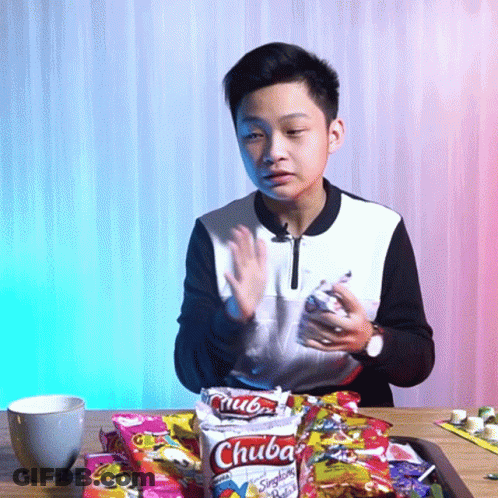 Young Boy Sitting With Bag Of Chuba Chips GIF