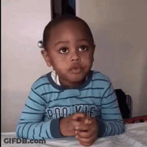 Young Boy Sitting With Hands Folded GIF