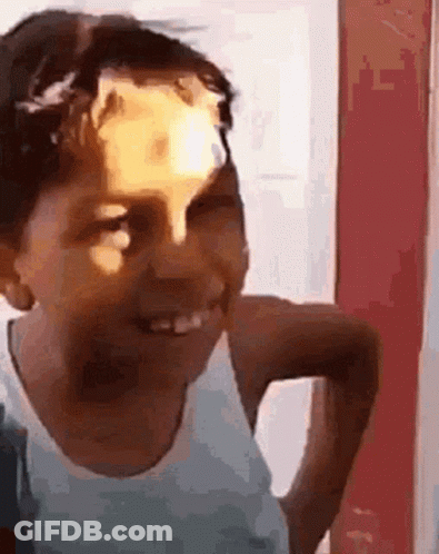 Young Boy Smiling With Sticker On Head GIF