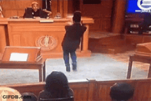 Young Boy Standing Before Judge In Courtroom GIF