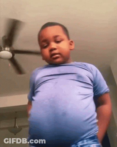 Young Boy Standing In Front Of Ceiling Fan GIF