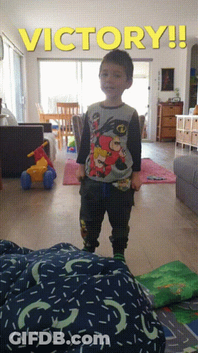 Young Boy Standing Under Victory Sign GIF