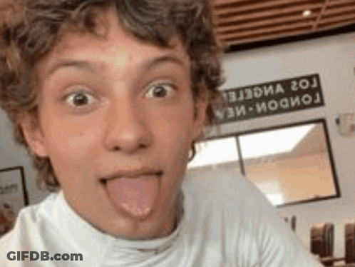 Young Boy Sticking Tongue Out Taking Selfie GIF