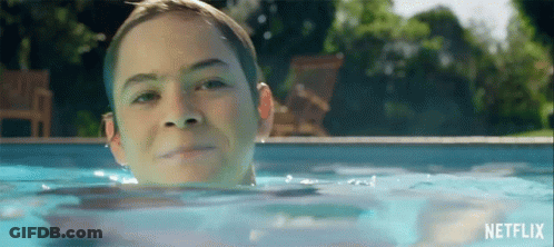 Young Boy Swimming In Pool With Netflix Logo GIF