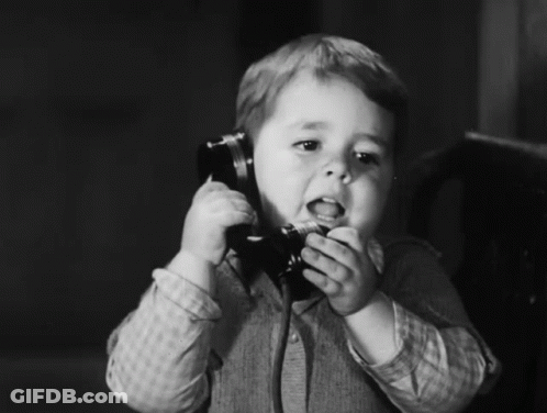 Young Boy Talking On Telephone GIF