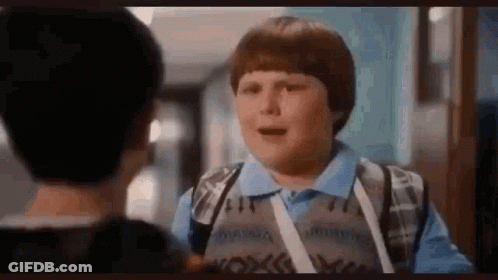 Young Boy Talking To Another Boy In Hallway GIF