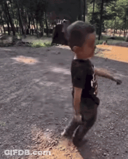 Young Boy Walking On Dirt Road GIF