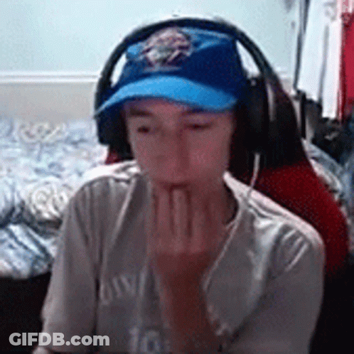 Young Boy Wearing Headphones And Blue Hat GIF