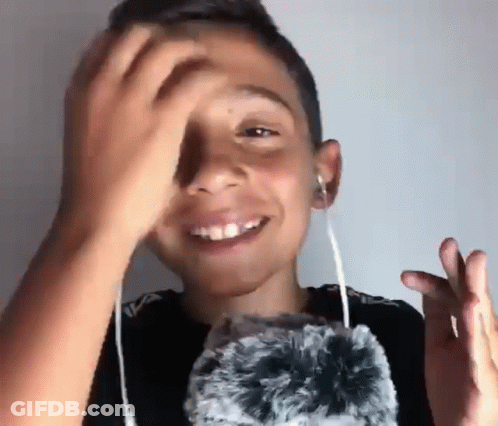 Young Boy Wearing Headphones Holding Stuffed Animal GIF