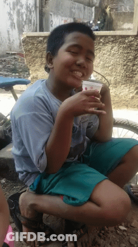 Young Boy Wearing Shirt Saying A Drinking From Cup GIF