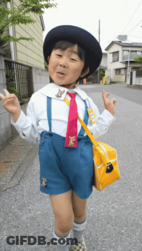 Young Boy White Shirt Blue Shorts Red Tie Yellow Bag GIF