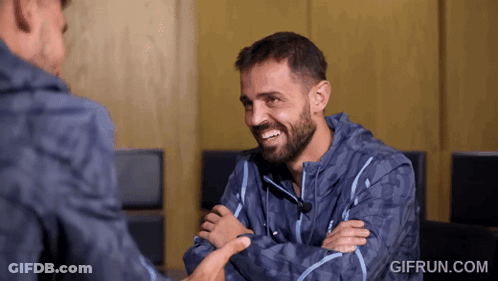 Young Boy With Backpack Talking To Another Boy In Hallway GIF