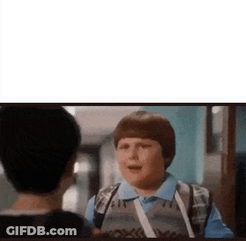 Young Boy With Backpack Talking To Another Boy In Hallway GIF