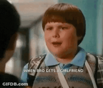 Young Boy With Backpack Talking To Boy In Hallway GIF