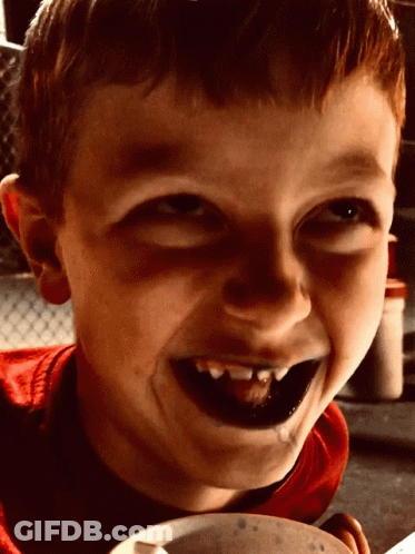 Young Boy With Black Teeth Smiling Holding Bowl Of Food GIF