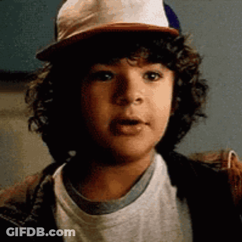 Young Boy With Curly Hair And Baseball Cap GIF