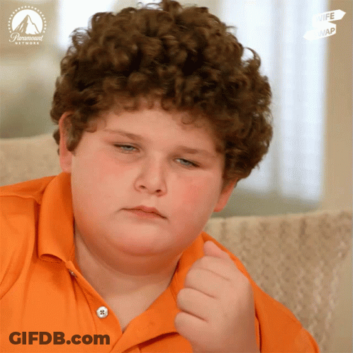 Young Boy With Curly Hair Sitting In Front Of Paramount Network Sign GIF