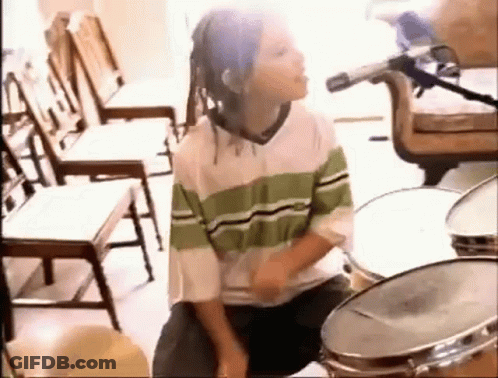 Young Boy With Dreadlocks Playing Drums GIF