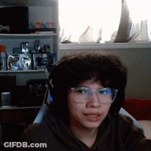 Young Boy With Glasses And Headphones By Window GIF