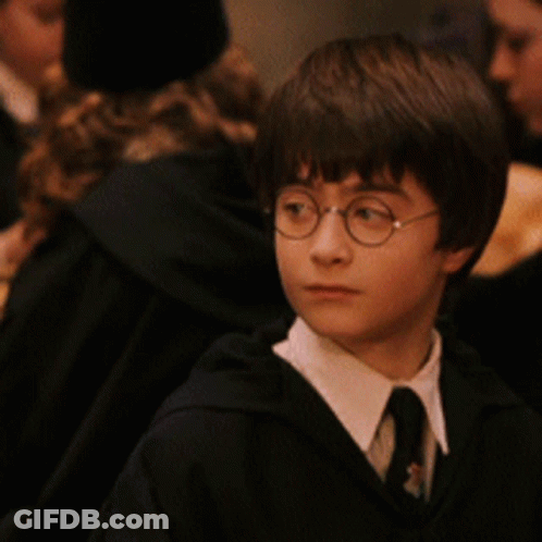 Young Boy With Glasses And Tie Looking At Camera GIF