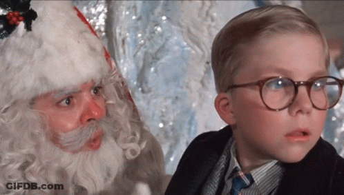 Young Boy With Glasses Next To Santa Claus GIF