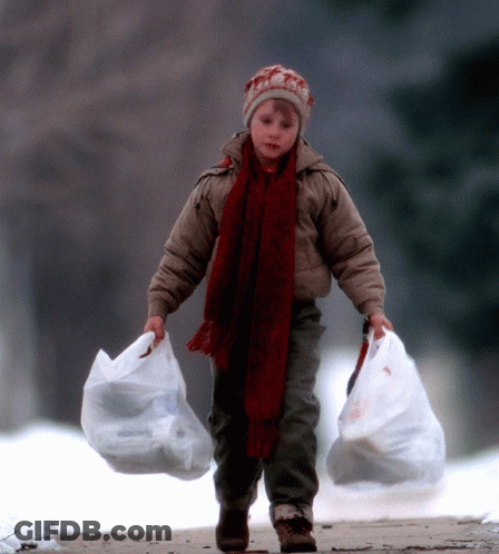 Young Boy With Hat And Scarf Carrying Two Bags GIF