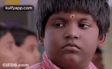 Young Boy With Red Flower Making Funny Face In Classroom GIF