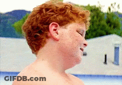 Young Boy With Red Hair And Freckles Standing In Front Of Pool GIF