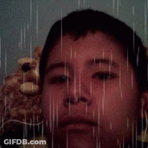 Young Boy With Teddy Bear In Rain GIF