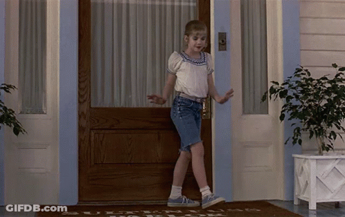 Young Girl At Door With Welcome Rug GIF