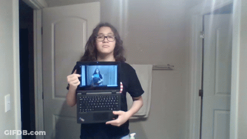 Young Girl Holding Laptop With Woman On Screen GIF