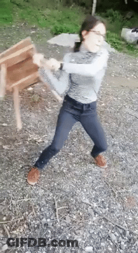 Young Girl Holding Wooden Chair GIF