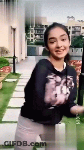 Young Girl In Black Sweatshirt And White Pants GIF