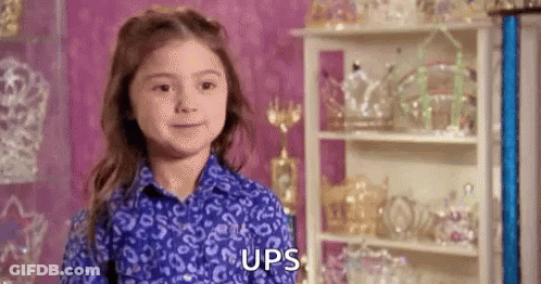 Young Girl In Blue Shirt Standing By Trophies GIF