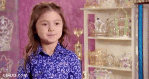 Young Girl In Blue Shirt With Trophies GIF