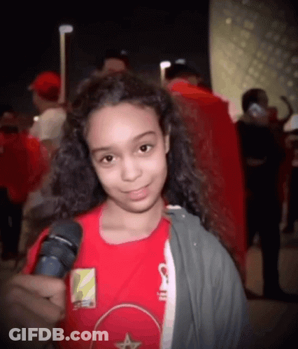 Young Girl In Red Shirt Holding Microphone GIF