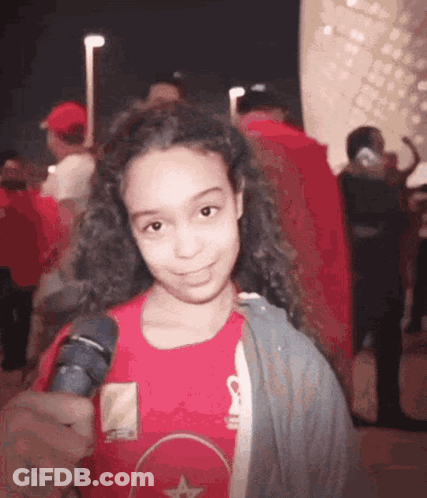 Young Girl In Red Shirt Holding Microphone GIF