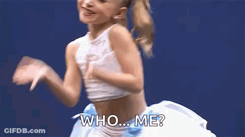 Young Girl In White Crop Top And Blue Skirt Dancing Saying Who Me GIF