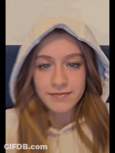 Young Girl In White Hoodie With Hood Up GIF