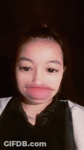 Young Girl Making Funny Face With Mouth Open Eyes Closed GIF