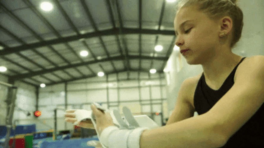 Young Girl Putting Chalk On Her Hand GIF