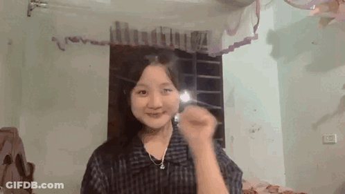 Young Girl Smiling In Front Of Mirror GIF