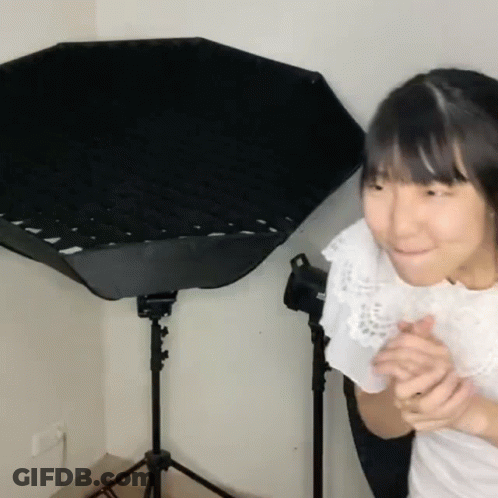 Young Girl Standing In Front Of Black Umbrella GIF
