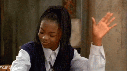 Young Girl Waving Hand At Desk GIF
