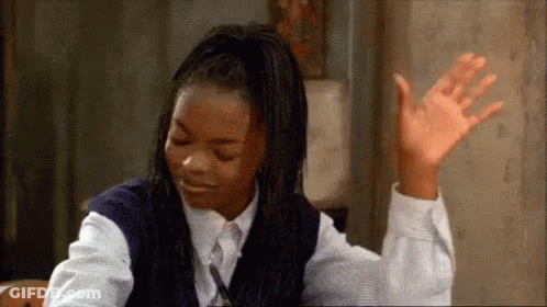 Young Girl With Hands Up At Desk GIF