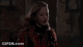 Young Girl With Long Hair In Dark Room GIF