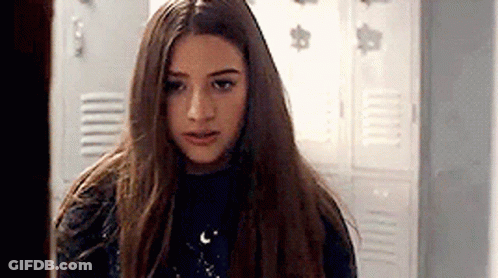 Young Girl With Long Hair In Front Of Locker GIF