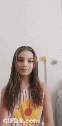 Young Girl With Long Hair In Striped Dress And Flower GIF
