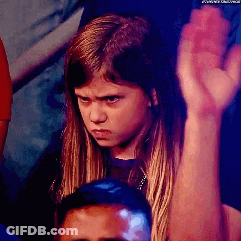 Young Girl With Serious Look Holding Fist Up GIF