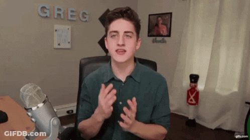 Young Man At Microphone With Greg On Wall GIF